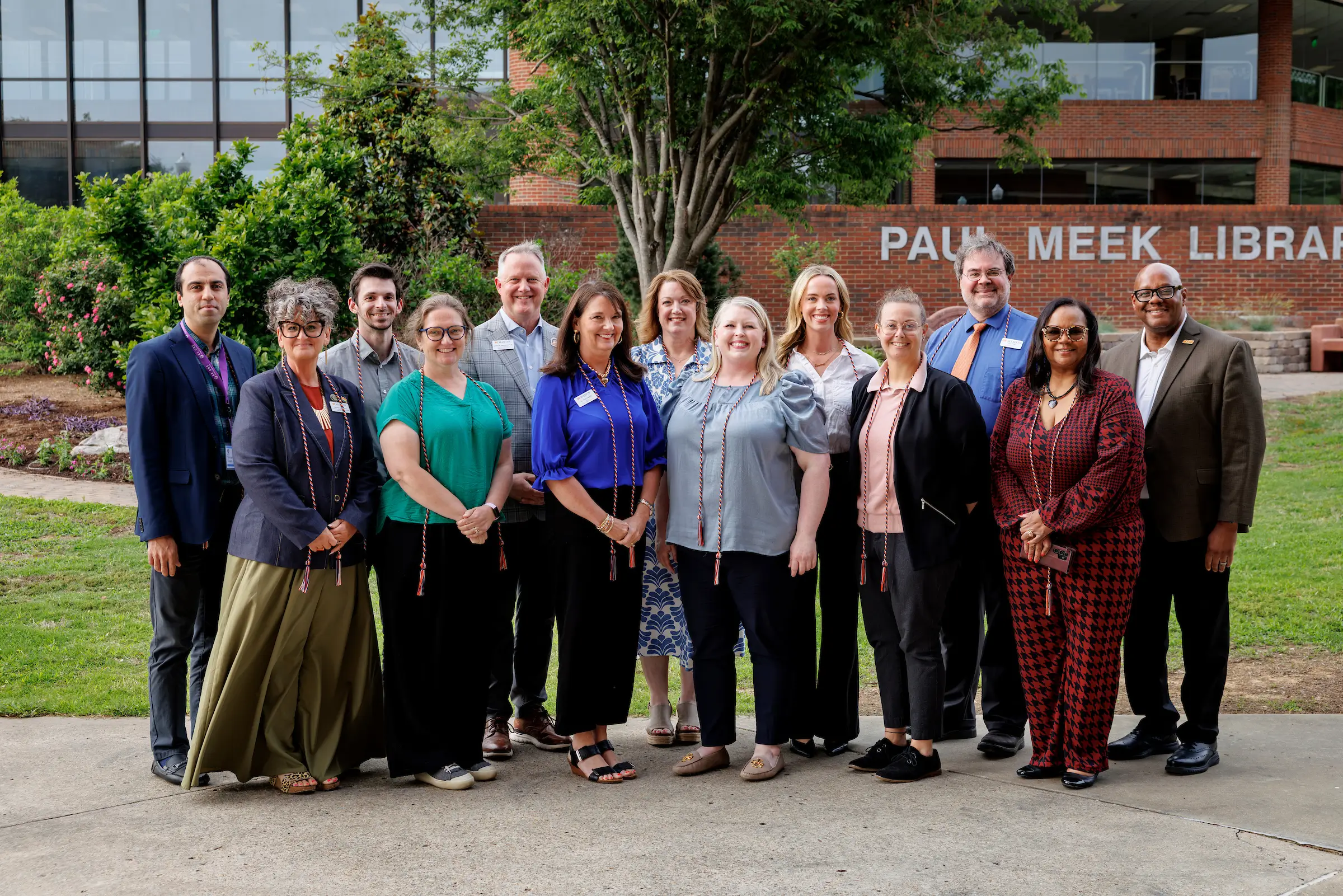 Members of the Chancellor's Leadership Academy with Chancellor Yancy Freeman outside Paul Meek Library.