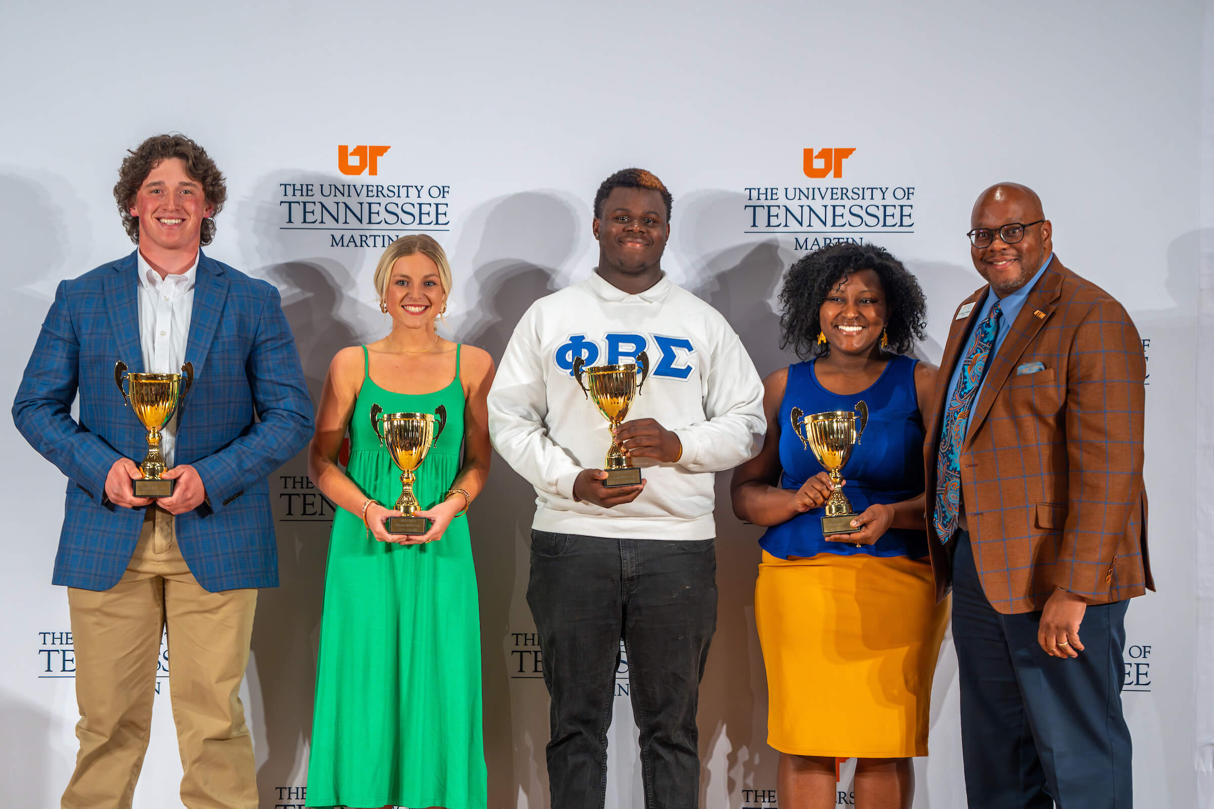 students in a line holding awards during the greek awards ceremony